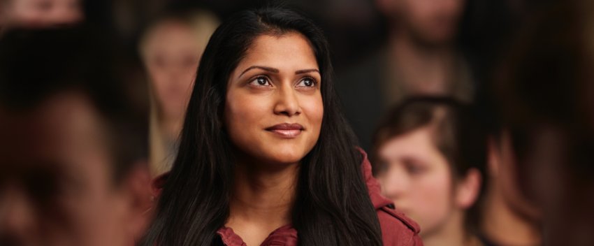 A woman with a smile gazing upward