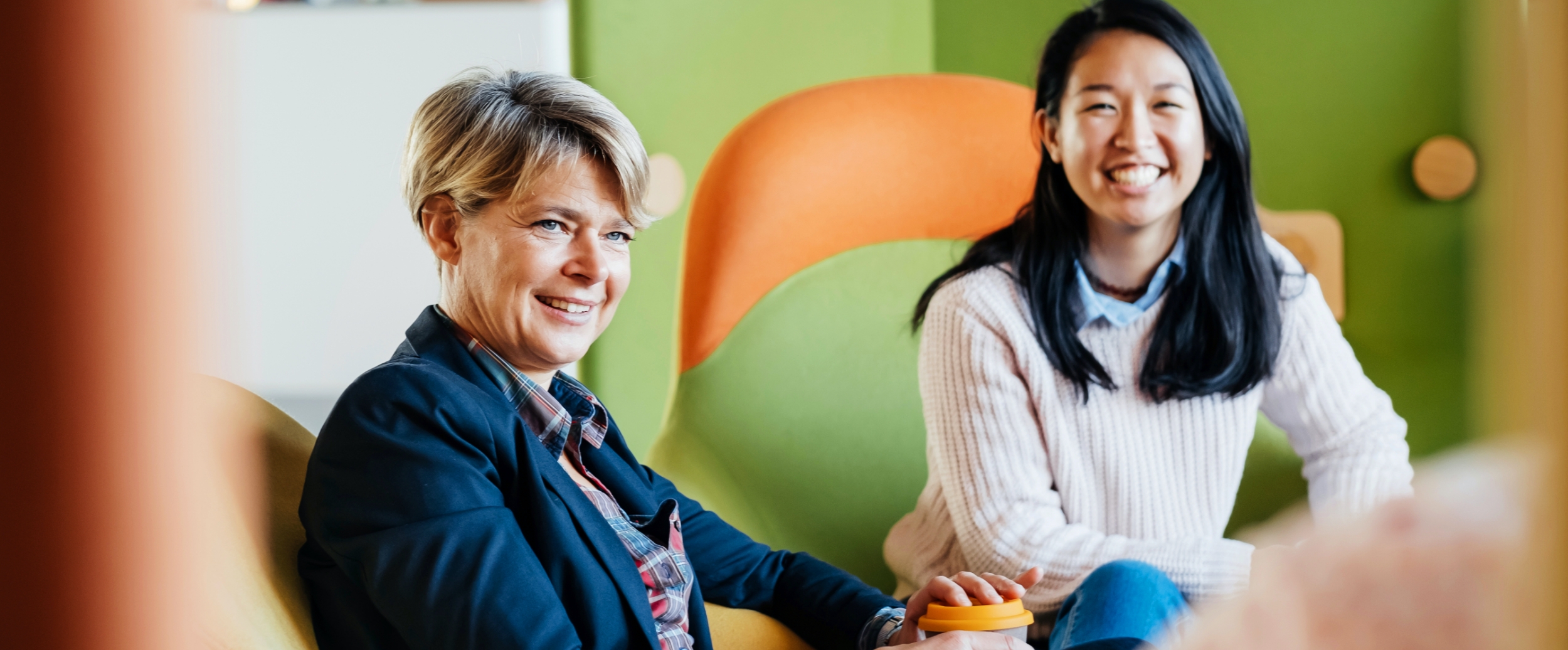 Two women with a smile looking at the camera