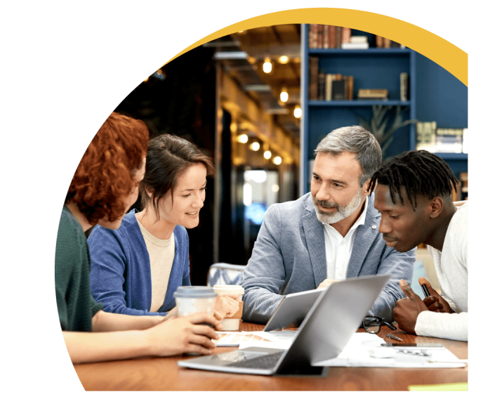 A group of employees having business discussion sitting at the office desk