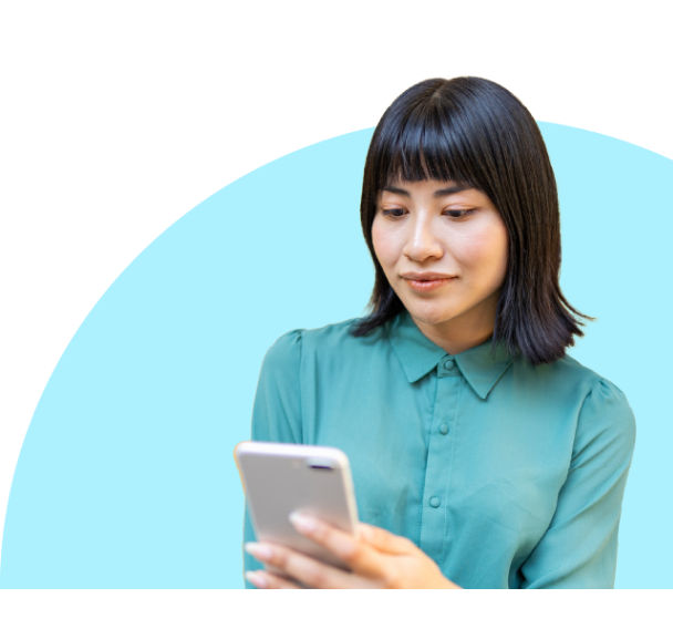 Headshot of a woman in a sea green t-shirt and looking at the phone screen