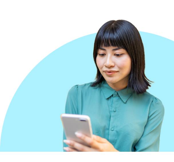 Headshot of a woman in a sea green t-shirt and looking at the phone screen