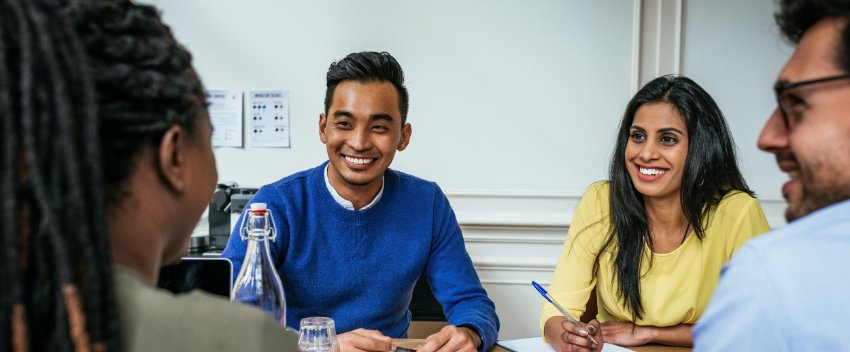 A group of young professionals at the meeting table