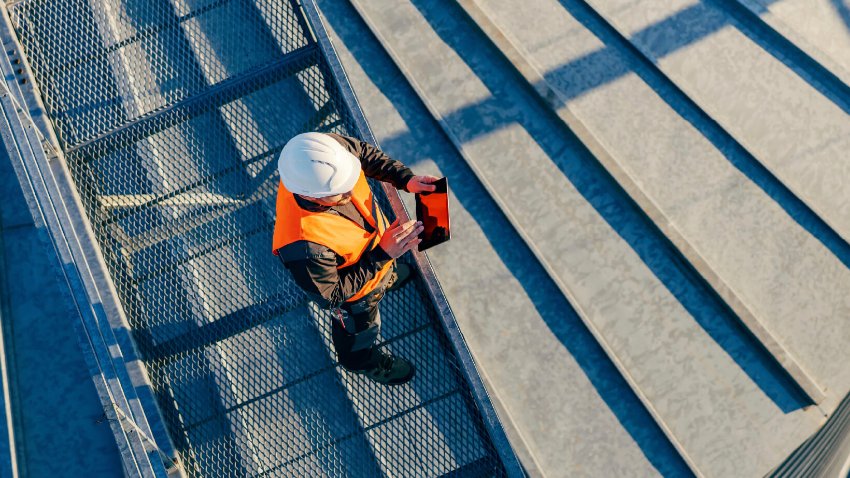 A civil engineer in safety gear inspecting construction site