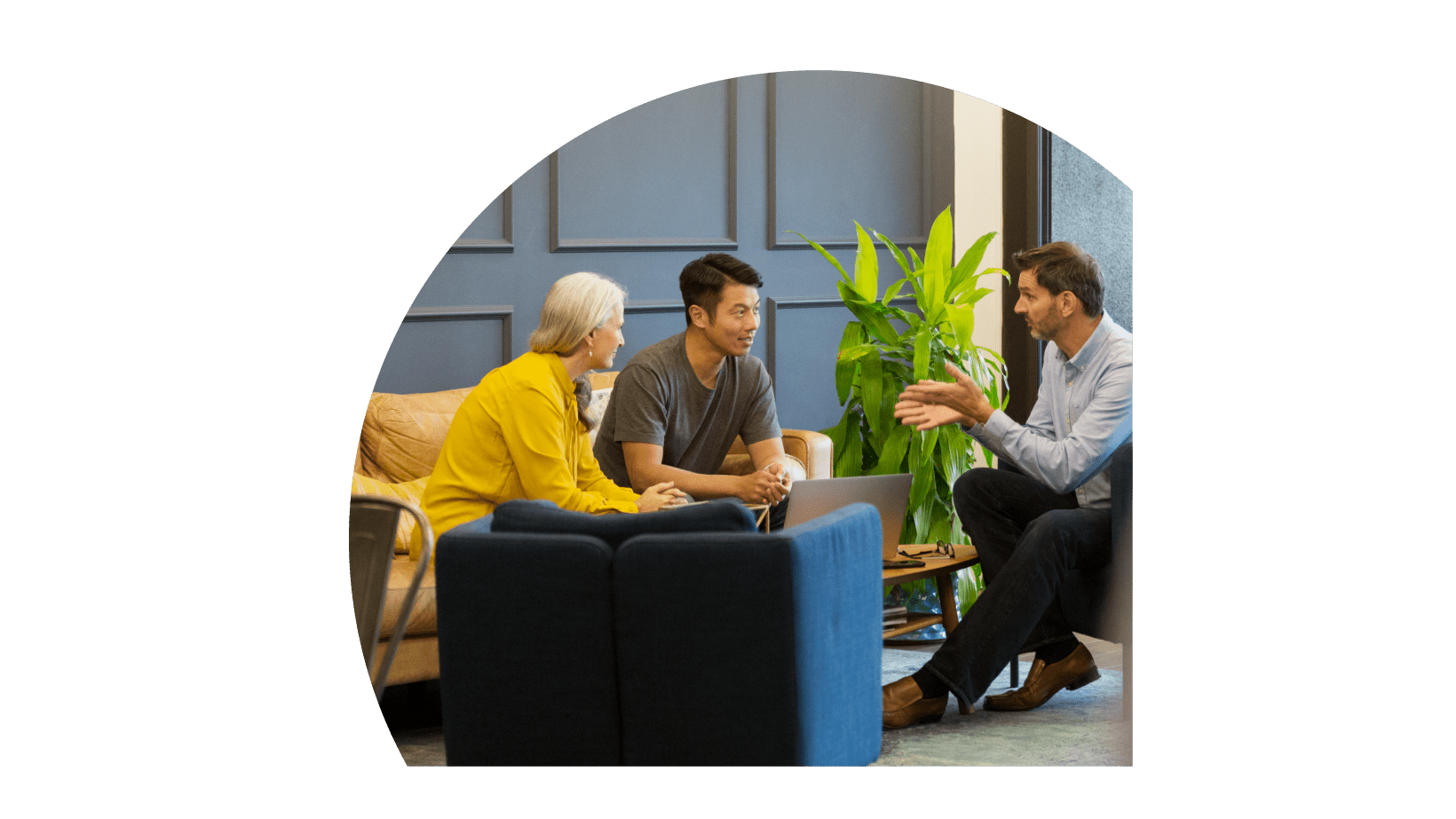 A group of three people in a meeting at lobby