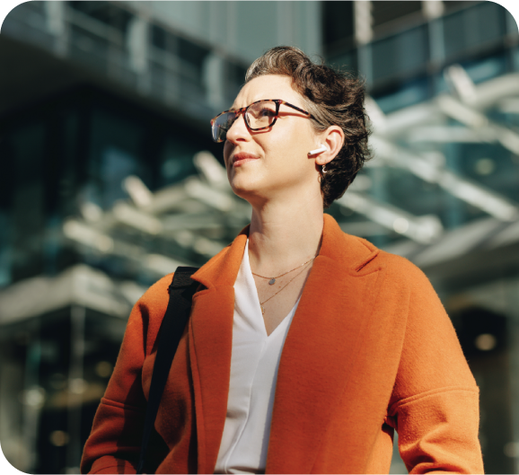 Business woman in orange gazing up