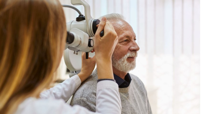 ENT physician looking into patient's ear with an instrument