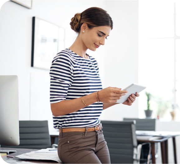 A young woman using tablet at work place