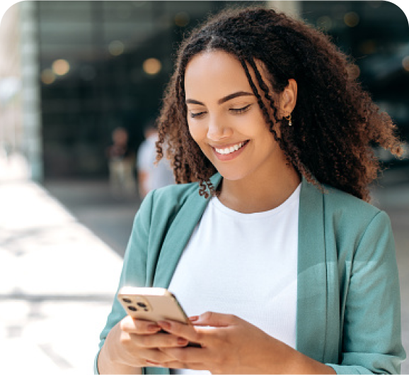 A woman looking at phone screen with a smile