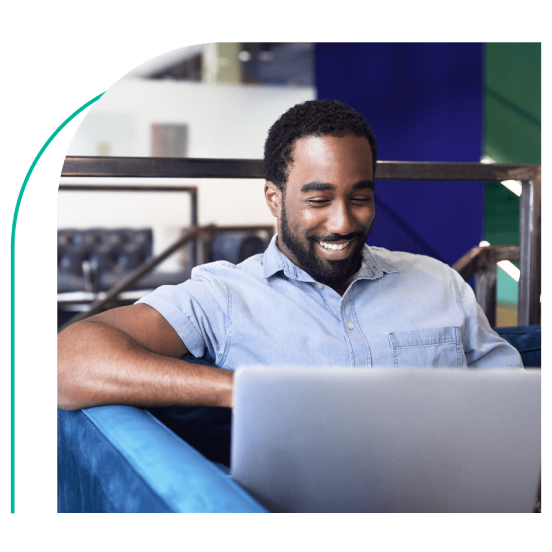 A gentleman looking at laptop screen with a smile