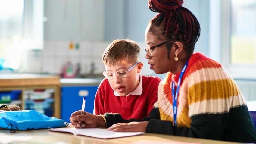 A school teacher helping a student